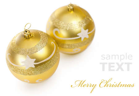 Two Christmas golden balls isolated on white background with copy space for text の写真素材