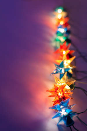 Christmas lights on dark background with copy space. Decorative garland