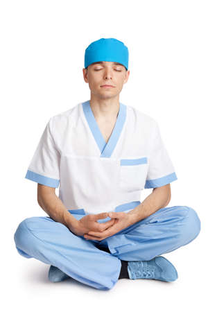 medical doctor meditating in lotus poseの写真素材