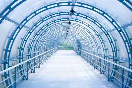 blue glass corridor in office centreの写真素材