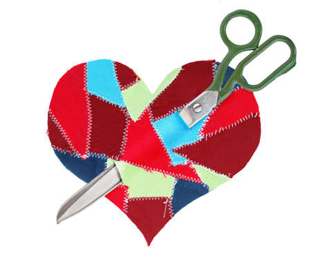 fabric scraps heart with scissors isolated on white backgroundの写真素材