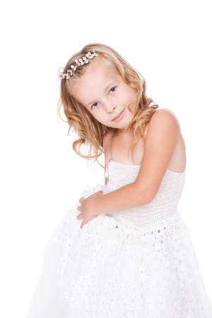 pretty little girl in beautiful white dress isolated on white backgroundの写真素材