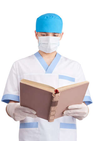 medical doctor reads the book isolated on white backgroundの写真素材