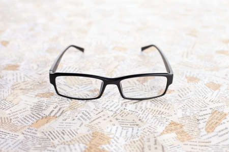reading glasses on paper background の写真素材