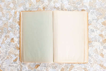 old opened book on paper background の写真素材