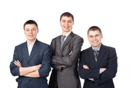 Three young smiling business men standing with folded hands isolated on white backgroundの写真素材