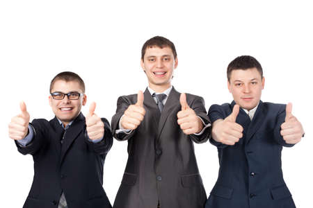 Three young business men laughing and giving the thumbs up sign isolated on white background の写真素材