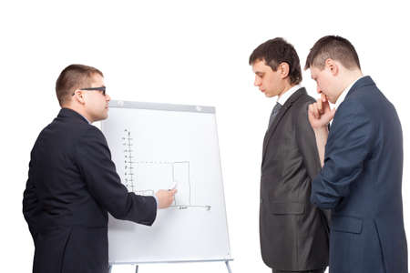 Three young  business men and a flipchart isolated on white backgroundの写真素材