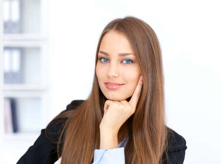 Closeup portrait of cute young business woman in officeの写真素材