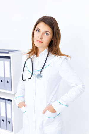 Portrait of young female doctor with stethoscope in hospitalの写真素材