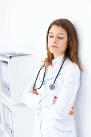 Portrait of pensive young female doctor in hospitalの写真素材
