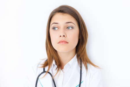 Portrait of pensive young female doctor の写真素材