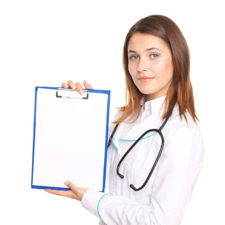 Portrait of young female doctor showing a blank paper sheet on clipboard isolated on white backgroundの写真素材