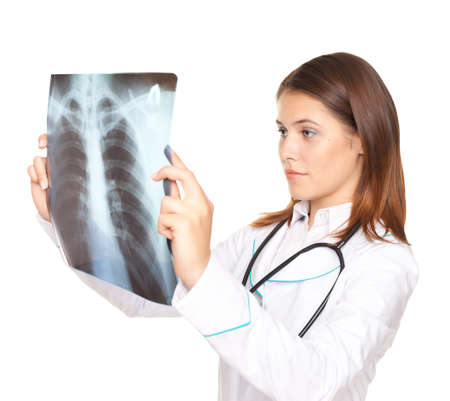 Young female doctor looking at the x-ray picture of lungs isolated on white backgroundの写真素材