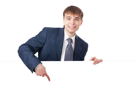 young smiling businessman holding white blank board isolated on white background の写真素材