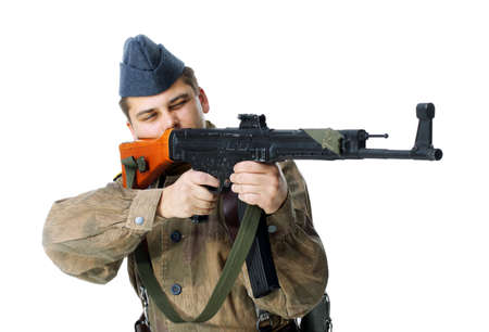 Soldier shoots submachine gun isolated on white backgroundの写真素材