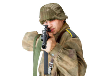 Soldier shoots submachine gun isolated on white backgroundの写真素材