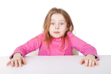 Cute little girl very surprised shrugging her shoulders isolated on white backgroundの写真素材