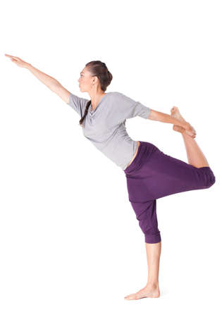 Young woman doing yoga exercise Natarajasana (Lord of the Dance Pose). Isolated on white backgroundの写真素材