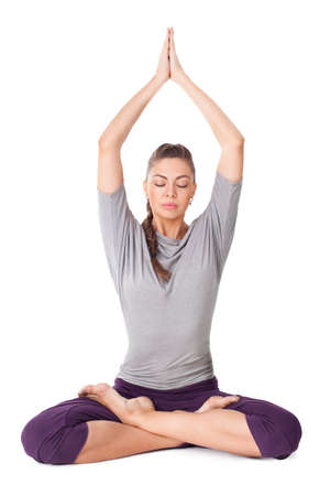 Young woman doing yoga exercise Padmasana (Lotus Pose). Isolated on white backgroundの写真素材