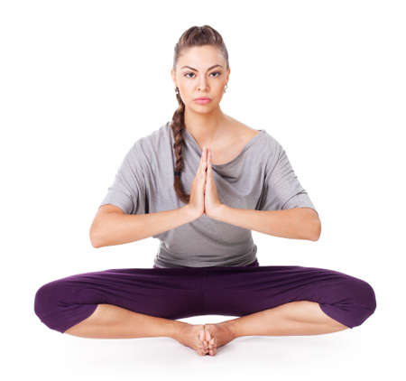 Young woman doing yoga asana Baddha Konasana (Bound Angle Pose). Isolated on white backgroundの写真素材