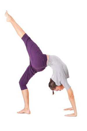 Young woman doing yoga exercise Wheel Pose. Isolated on white backgroundの写真素材