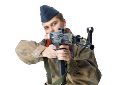 Soldier shoots submachine gun isolated on white backgroundの写真素材