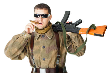 Soldier wearing sunglasses with machine gun smoking a cigar isolated on white background