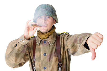 Soldier smoking a cigar and gives a thumb down isolated on white backgroundの写真素材