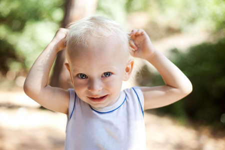 Portrait of a smiling little boy in the parkの写真素材