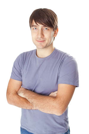 Portrait of happy smiling man standing with hands folded against isolated on white backgroundの写真素材