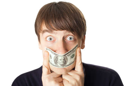Portrait of young man covering his mouth a 100 dollar banknote isolated on white backgroundの写真素材