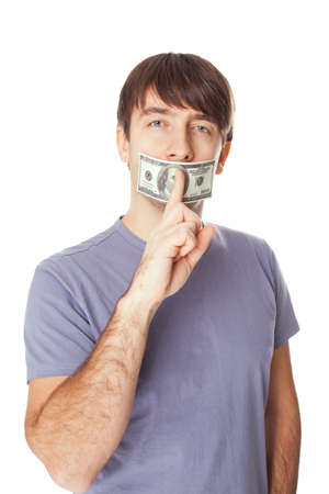 Young man with his mouth sealed by a hundred dollar bills for bribe concept isolated on white backgroundの写真素材