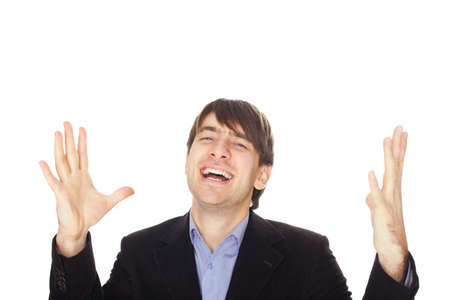 Excited young business man with arms raised in success isolated on white backgroundの写真素材