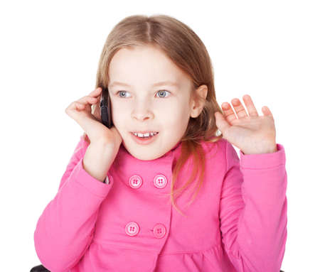 Portrait of surprised little girl with cell phone isolated on white backgroundの写真素材