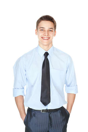 Portrait of handsome young smiling successful businessman standing with hands in pockets isolated on white backgroundの写真素材