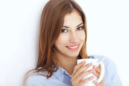 Portrait of a young woman with cup of tea or coffee の写真素材