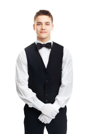 Portrait of young smiling waiter isolated on white background の写真素材