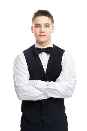 Portrait of young smiling waiter isolated on white background の写真素材