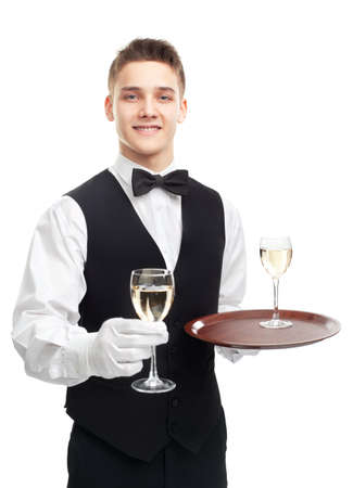 Portrait of young happy smiling waiter holding glasses of white wine isolated on white backgroundの写真素材