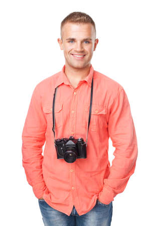 Portrait of a happy smiling young man with a camera isolated on white backgroundの写真素材