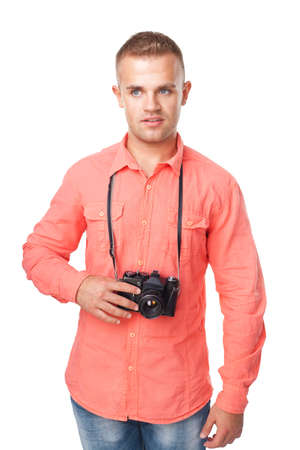 Portrait of a happy smiling young man with a camera isolated on white backgroundの写真素材