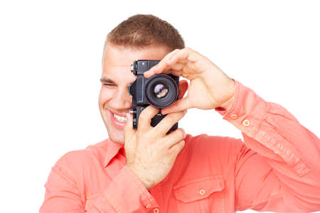 Young photographer taking pictures with his camera isolated on white backgroundの写真素材