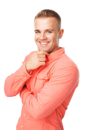 Portrait of happy smiling young man holding hand up to chin with arms folded isolated on white backgroundの写真素材