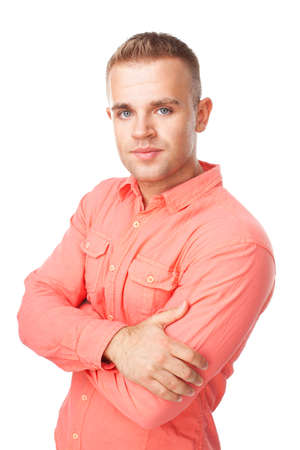 Portrait of happy smiling young man holding hand up to chin with arms folded isolated on white backgroundの写真素材
