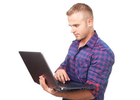 Young man using laptop computer isolated on white backgroundの写真素材