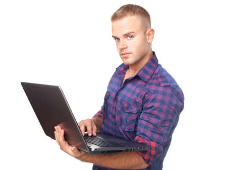 Young man using laptop computer isolated on white backgroundの写真素材