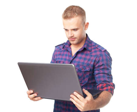 Young man using laptop computer isolated on white backgroundの写真素材