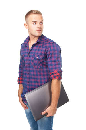 Portrait of happy smiling young man holding laptop isolated on white backgroundの写真素材