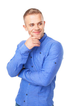 Portrait of smiling young man wearing a blue shirt looks aside isolated on white backgroundの写真素材